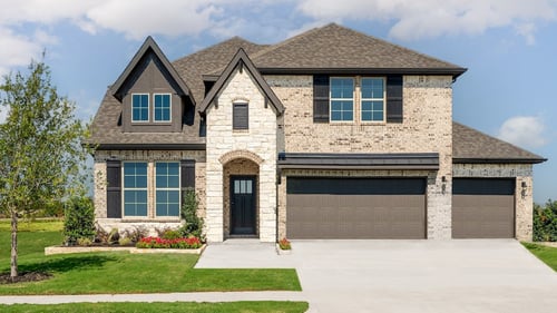 two-story new home with brick exterior and garage