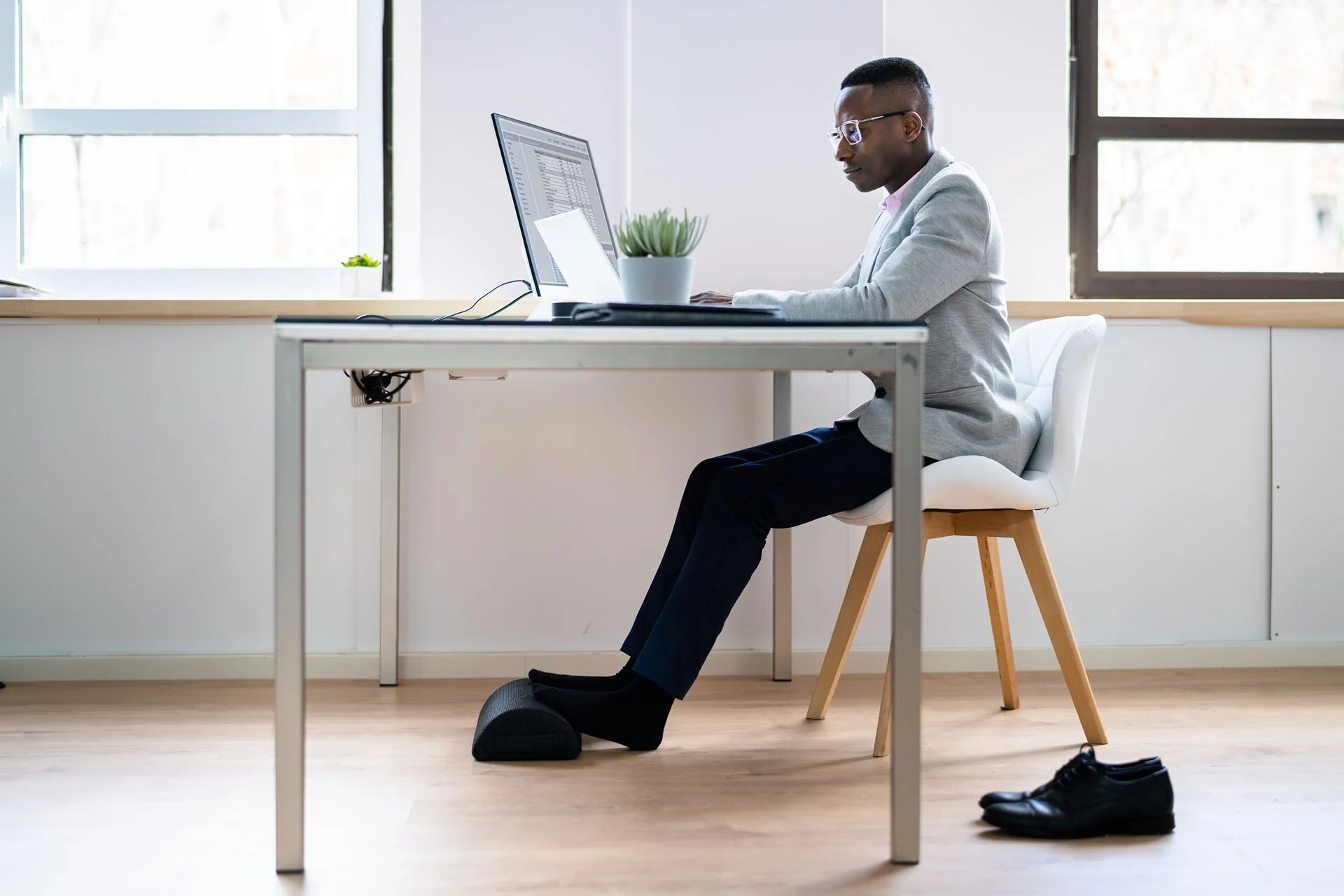 a man with a desk job doing foot stretches