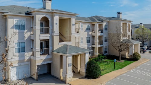 Exterior of apartment with view of resident parking at Estancia Apartments, Tulsa, Oklahoma