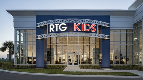 Front view of RTG Kids store in Daytona Beach, Florida, with large glass windows and illuminated signage.