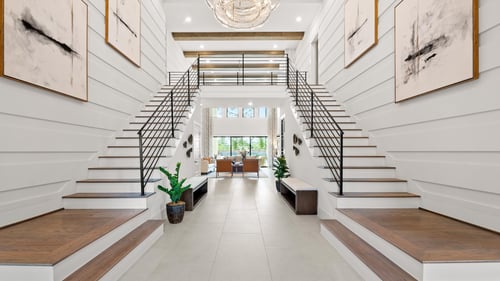 Expansive foyer with generous ceiling heights and double staircase