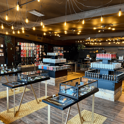 Wide view of retail interior at Hemp & Tea Company Charlotte with infused drinks, pre-rolls, and hemp products under ambient lighting.
