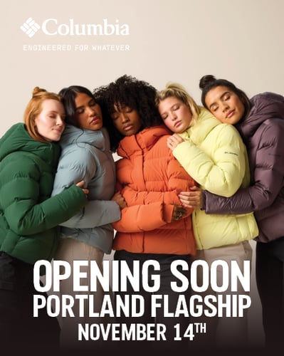 Women hugging in puffer jackets.