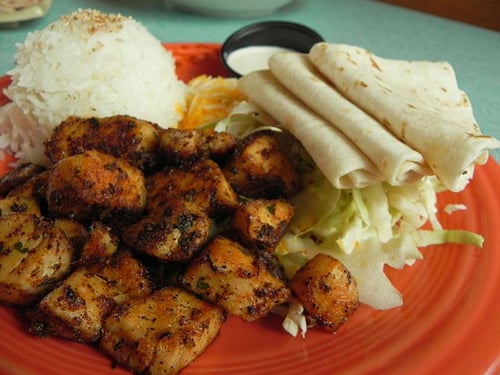 Mama’s World Famous Fish Tacos - Fresh Mahi Mahi marinated and sautéed. Served with cheddar/jack cheese, scallions, jasmine rice, shredded cabbage, flour tortillas and our lime sour cream to top them with.