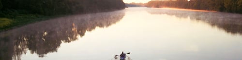 Kayak on lake during sunset