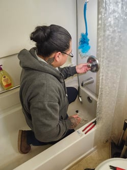 Our bluefrog Plumbing apprentice Daniel assisting with a shower valve repair in Northeast Portland