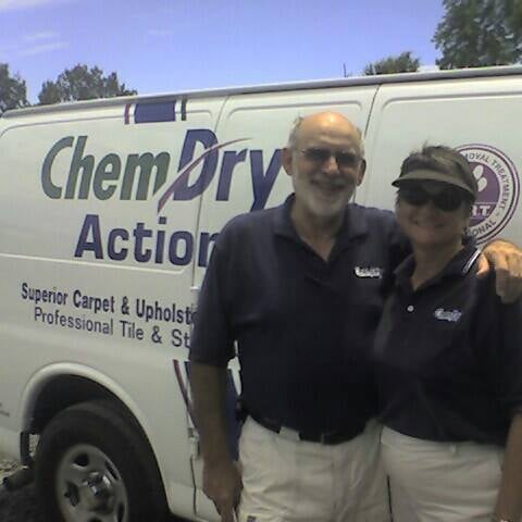 Owners of Chem-Dry Action standing in front of their cleaning van