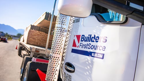 Builders FirstSource semi truck carrying trusses.