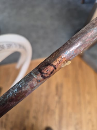 a circle drawn around the deteriorated section of an old galvanized supply line