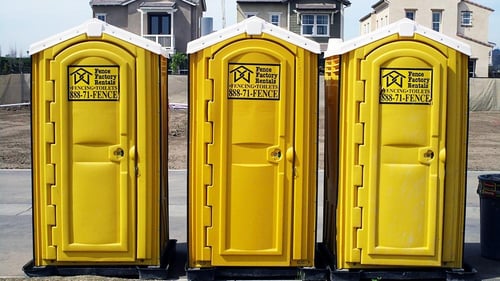 Three portable toilets provided by Fence Factory Rentals - Fresno.