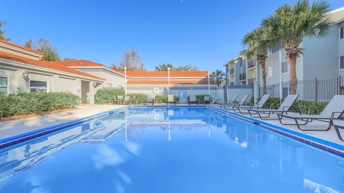 swimming pool and sundeck with lounge chairs at Oak Chase 1 in Tampa, FL