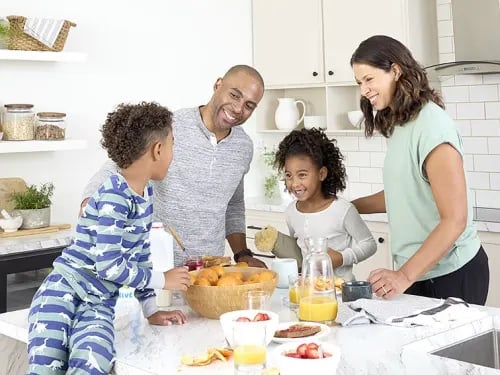 Family makes a meal in their kitchen.