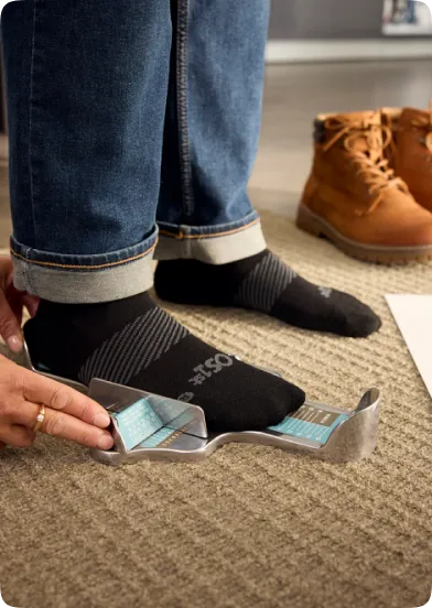 person getting measured with a brannock device