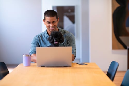 Man with dog on laptop