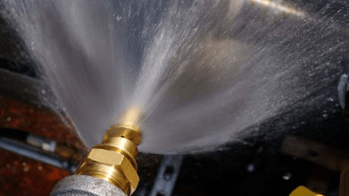 closeup of a sprinkler shooting out water