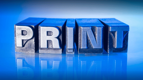 the word PRINT spelled out on printing press blocks