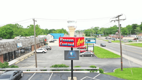 frozen custard sign with a digital sign below showing company logo