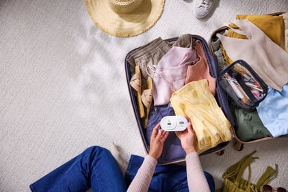 Person packing their travel carbon monoxide detector form Kidde