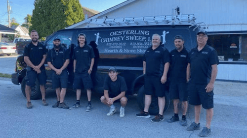 group of technicians in front of service van