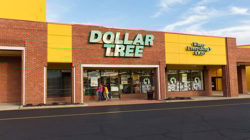 Two people in front of exterior of Dollar Tree