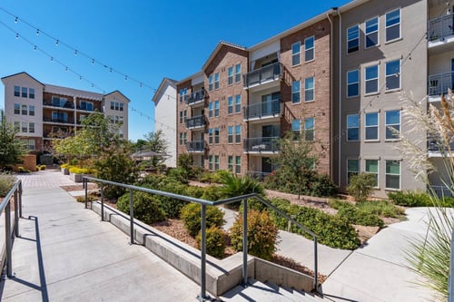 steps leading up to an apartment building with stairs and landscaping at City View St. George Apartments, Utah
