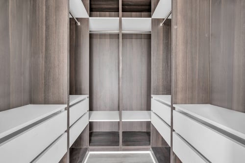 Walk-in closet with white drawers and shelving at The Franklin at Marlboro Apartments, Marlboro, 07746