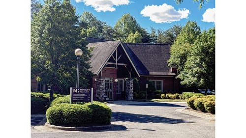 Directional sign in front of the main entrance at Novant Health Surry Medical Associates.