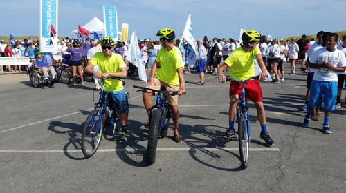 three people awaiting to bike ride