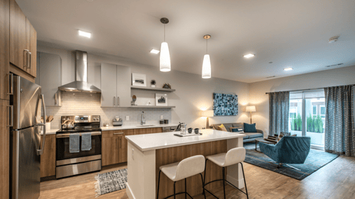 Modern kitchen and living room in the Tempo Cambridge apartments