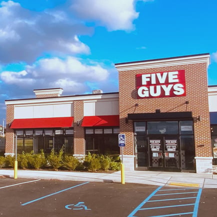 Exterior photograph of the entrance to the Five Guys restaurant at 15 Radcliffe Drive in Moosic Pennsylvania.