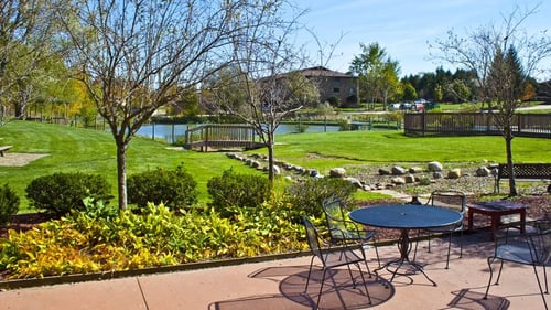 Patio overlooking the pool and pond at Medina Village Apartments, Integrity Realty LLC, Medina, Ohio