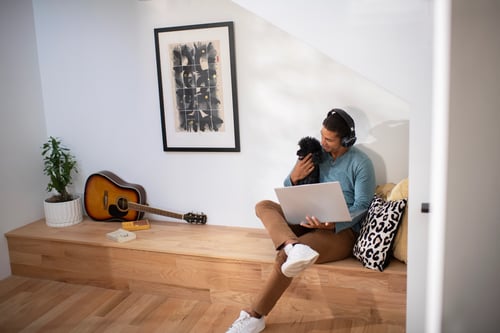 Man with headphones and dog in nook