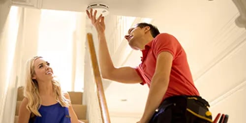 couple-installing-alarm