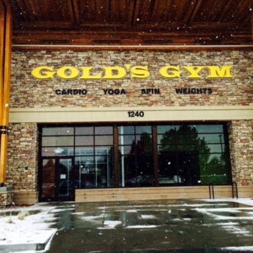 Exterior entrance of Gold's Gym in Longmont with the club's storefront and main entrance.