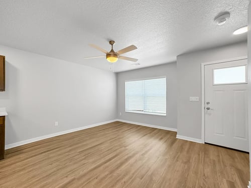 Spacious room with ceiling fan and large windows, Hawthorne Pointe, Bondurant, IA