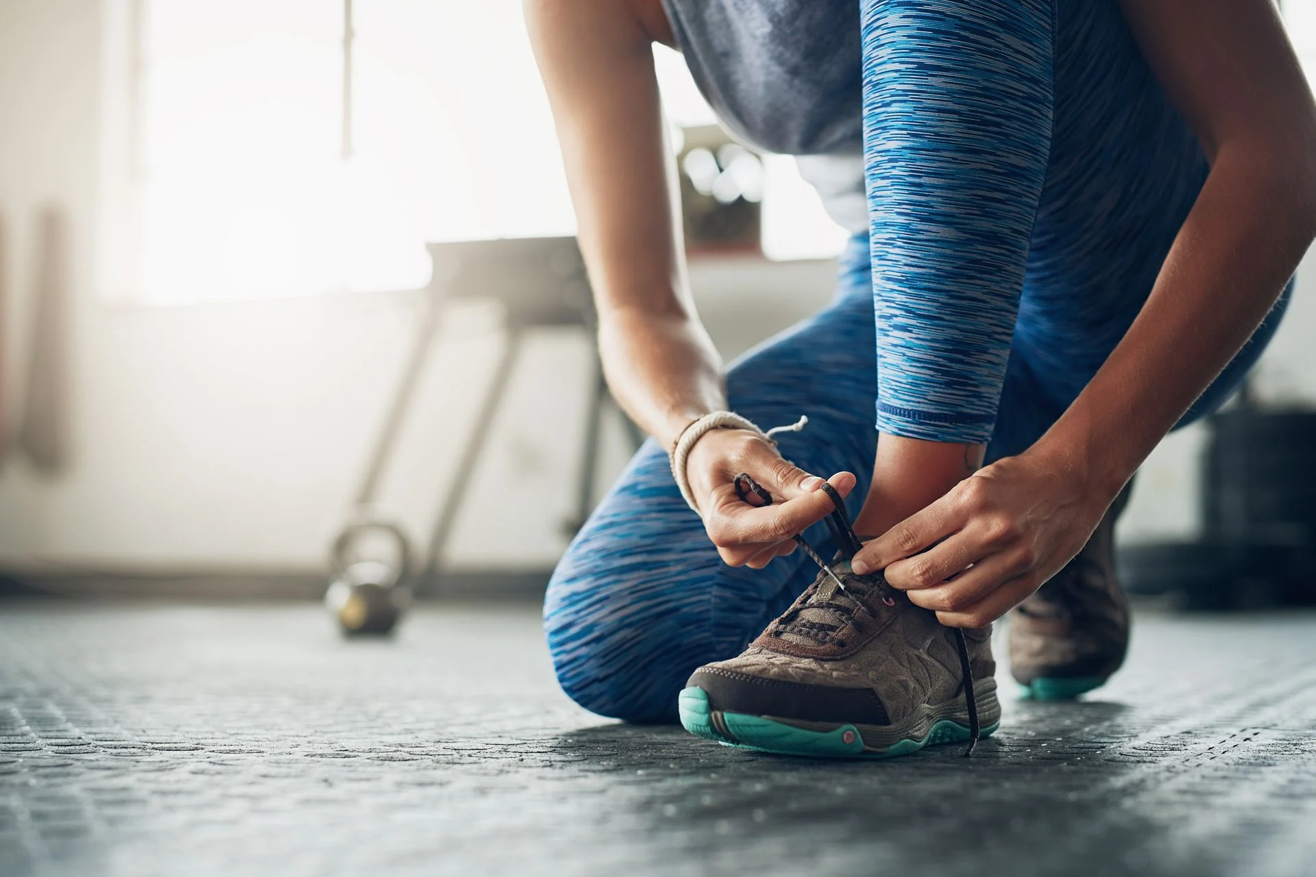 person tying their shoelaces before being active