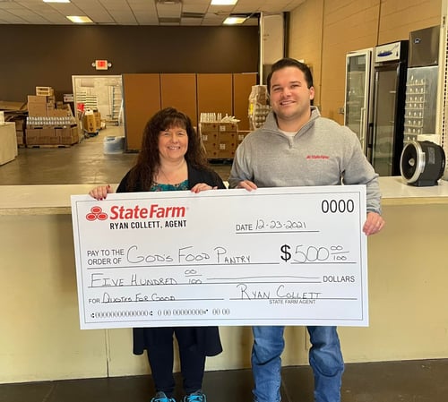 Agent Ryan standing and smiling with donation