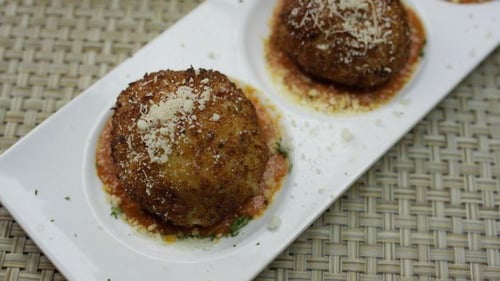 two large meatballs on white plate