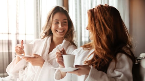 Two women enjoying a spa day with tea.