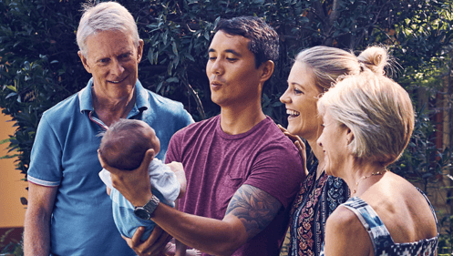 family gazing at newborn child/grandchild