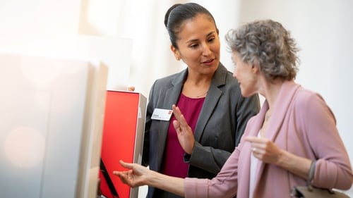 Wells Fargo employee helping a woman.