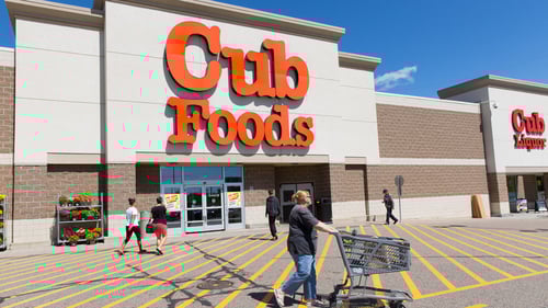 Person with shopping cart walking in front of Cub Foods at Sun Ray Shopping Center