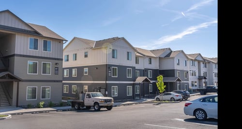 A row of modern townhouses with cars parked in front at Westgate Apartment Homes, Pendleton, Oregon