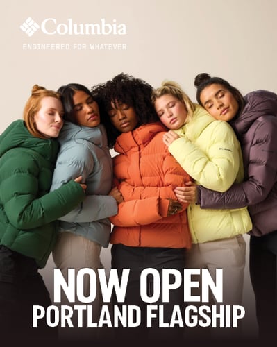 Women hugging in puffer jackets.