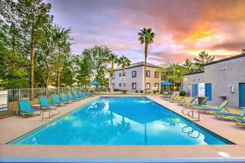 A swimming pool surrounded by lounge chairs at The 95 Apartments, Las Vegas, NV, 89129