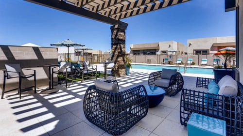 shaded pool lounge area and sun deck at avilla centerra crossing in Goodyear, AZ
