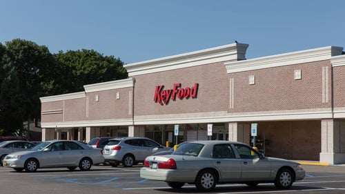 Cars sporatically parked in front of Key Food