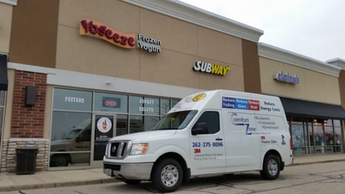 company van in the front of a building