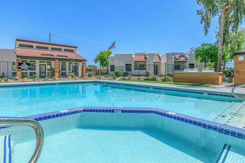 a large swimming pool with apartments in the background at Saltéra Apartments, Mesa, 85204