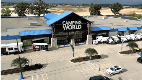 exterior view of camping world deforest WI storefront with RVs in front and stormy sky